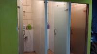 a bathroom with two white doors and a toilet at Taroko Susi Space in Xincheng