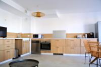 a kitchen with wooden cabinets and stainless steel appliances at Arbre Blanc, une folie montpelliéraine in Montpellier