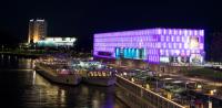 a group of boats docked next to a building with purple lights at Traumapartment Pöstlingberg, reservierter Parkplatz, 4 Schlafzimmer in Linz