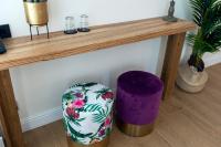 a wooden table with a vase sitting under a table at Quentin Golden Bear Hotel in Amsterdam
