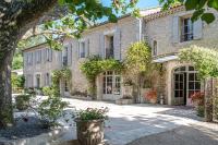 an old stone house with a courtyard with flowers at Hôtel Mas Valentine in Saint-Rémy-de-Provence