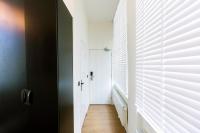 a hallway with a white door and a window at Quentin Golden Bear Hotel in Amsterdam