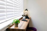 a room with a wooden table next to a window at Quentin Golden Bear Hotel in Amsterdam