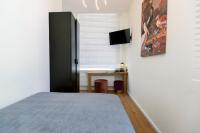 a bedroom with a bed and a desk and a window at Quentin Golden Bear Hotel in Amsterdam