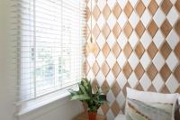 a bedroom with a checkered wall and a window at Quentin Golden Bear Hotel in Amsterdam