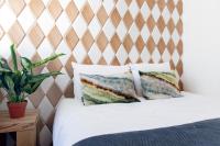 a bedroom with a bed with a wooden headboard at Quentin Golden Bear Hotel in Amsterdam