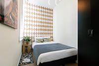 a bedroom with a bed and a window at Quentin Golden Bear Hotel in Amsterdam