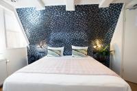 a bedroom with a large bed with a black wall at Quentin Golden Bear Hotel in Amsterdam