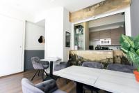 a kitchen and dining room with a table and chairs at Quentin Golden Bear Hotel in Amsterdam
