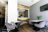 a meeting room with two tables and chairs at Quentin Golden Bear Hotel in Amsterdam