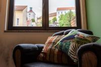 a chair with a pillow in front of two windows at Timeout Heritage Hotel Zagreb in Zagreb