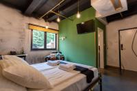 a large bed in a room with a green wall at Timeout Heritage Hotel Zagreb in Zagreb