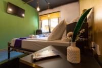a room with a bed with a table and a vase with flowers at Timeout Heritage Hotel Zagreb in Zagreb