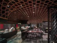 a restaurant with a wooden ceiling and tables and chairs at New World Beijing Hotel in Beijing