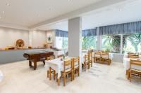 a dining room with tables and a pool table at Astris Sun Hotel in Astris