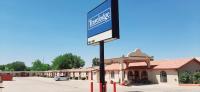 a sign on a pole in front of a building at Travelodge by Wyndham Kanab in Kanab