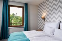 Postel nebo postele na pokoji v ubytování Hotel Adalbert Szent Tamás ház