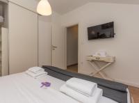 Posteľ alebo postele v izbe v ubytovaní Apartmani Julija