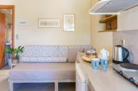 a kitchen counter with a bench in a kitchen at Voulamandis House in Kambos