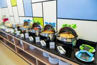 a buffet line with many different food dishes at Hotel Citradream Bandung in Bandung