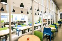 a dining room with tables and chairs at Hotel Citradream Bandung in Bandung