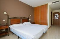 A bed or beds in a room at Hospedium Hotel Don Fidel