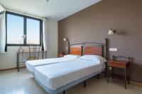 A bed or beds in a room at Hospedium Hotel Don Fidel
