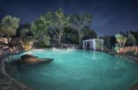 a large pool of blue water at night at Puntebianche B&amp;B in Ceglie Messapica