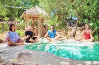 a group of people sitting around a swimming pool at Puntebianche B&amp;B in Ceglie Messapica