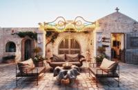 a patio with a couch and chairs and a fountain at Puntebianche B&amp;B in Ceglie Messapica