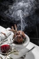 Un trozo de comida en un plato con humo. en Villa Geba Boutique Hotel, en Sveti Stefan