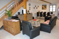 a waiting room with chairs and a table and stairs at Gîte Le Cep d&#39;Or Alsace in Saint-Hippolyte