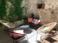 a patio with three chairs and a table and a couch at T2 centre ville avec extérieur in Avignon