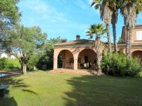 a house with a porch and a palm tree at Holiday Home Les Chênes - MAA200 by Interhome in Borgo