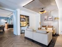 a living room with a couch and a table at Hotel Royal Saint Honore Paris Louvre in Paris