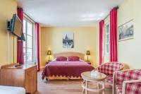 a bedroom with a bed and a table and chairs at Hôtel Du Théâtre Centre Historique Parking Gratuit in Metz
