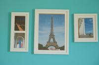 three framed pictures of the eiffel tower on a wall at Bonjour, Paris in Taitung City