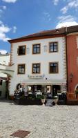 Un gran edificio blanco con un cartel en él. en Hotel Grand, en Český Krumlov