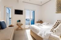 Posteľ alebo postele v izbe v ubytovaní Bluetopia Suites