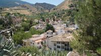 a village in the mountains with houses and trees at Casa Cueva “La Estrella” in Granada