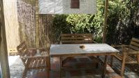 a wooden table and two chairs on a patio at Casa Cueva “La Estrella” in Granada