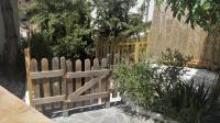 a wooden fence in front of a garden at Casa Cueva “La Estrella” in Granada
