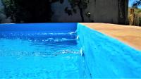 a blue swimming pool with blue water in it at Casa Cueva “La Estrella” in Granada