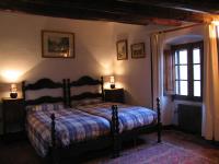 A bed or beds in a room at Castell de Riudabella