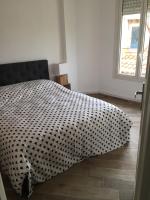 a bed with a black and white blanket on the floor at Centre ville Perpignan - Le Castillet in Perpignan
