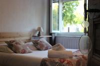 a bedroom with two beds and a window at Les saladelles in Salin-de-Giraud