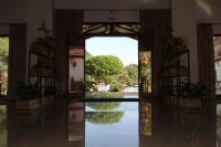 an entrance to a building with a reflection in the water at Hotel El Paso in Vejer de la Frontera