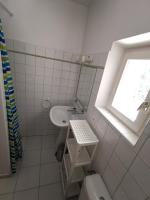 a bathroom with a sink and a toilet and a window at mas cantarello in Rognes