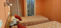 A bed or beds in a room at Hostal San Martin