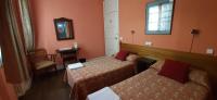 A bed or beds in a room at Hostal San Martin